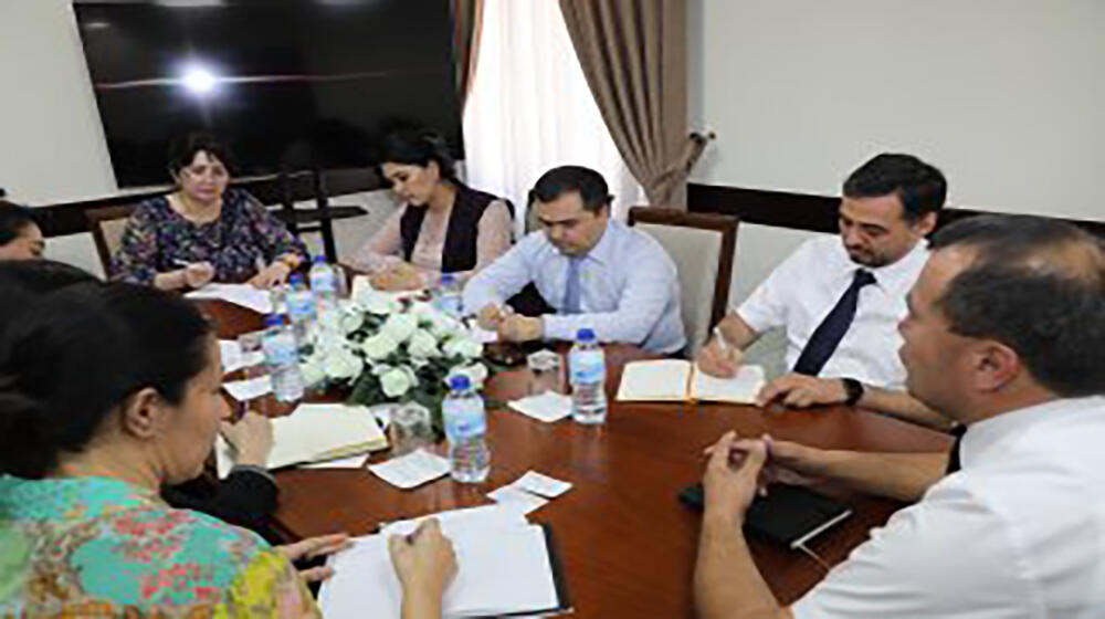 group of people -participants of the meeting sit at the table