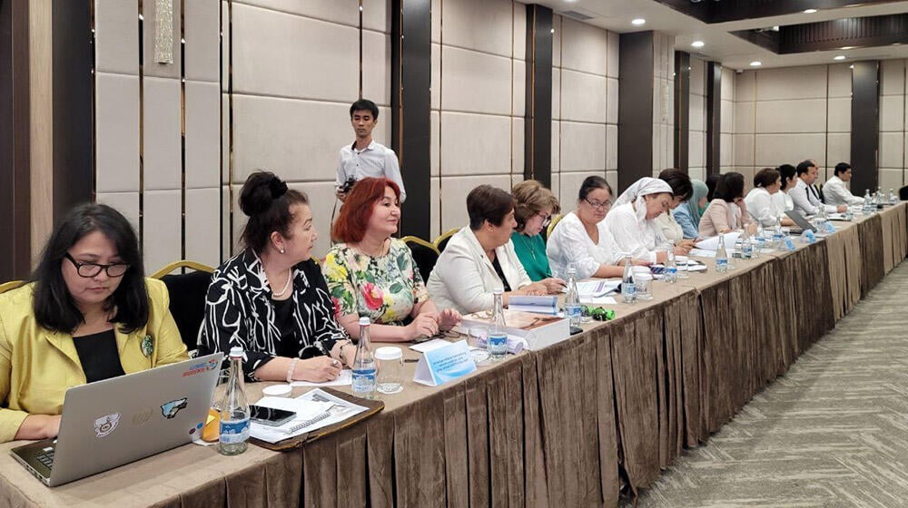 group of people -participants of the meeting sit at the table