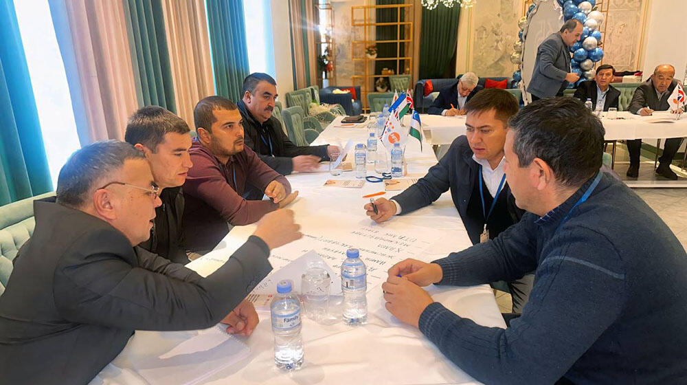 men around the table discussing