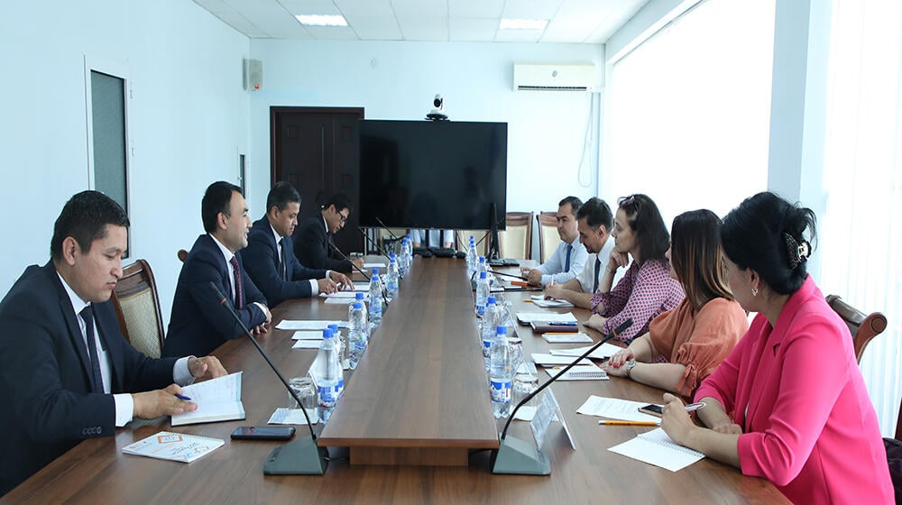 group of people -participants of the meeting sit at the table