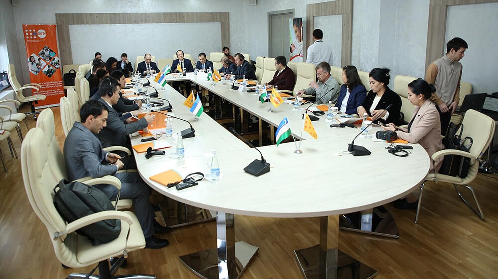 group of people -participants of the meeting sit around the table