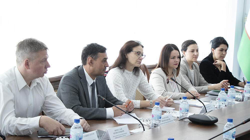 group of people -participants of the meeting sit at the table