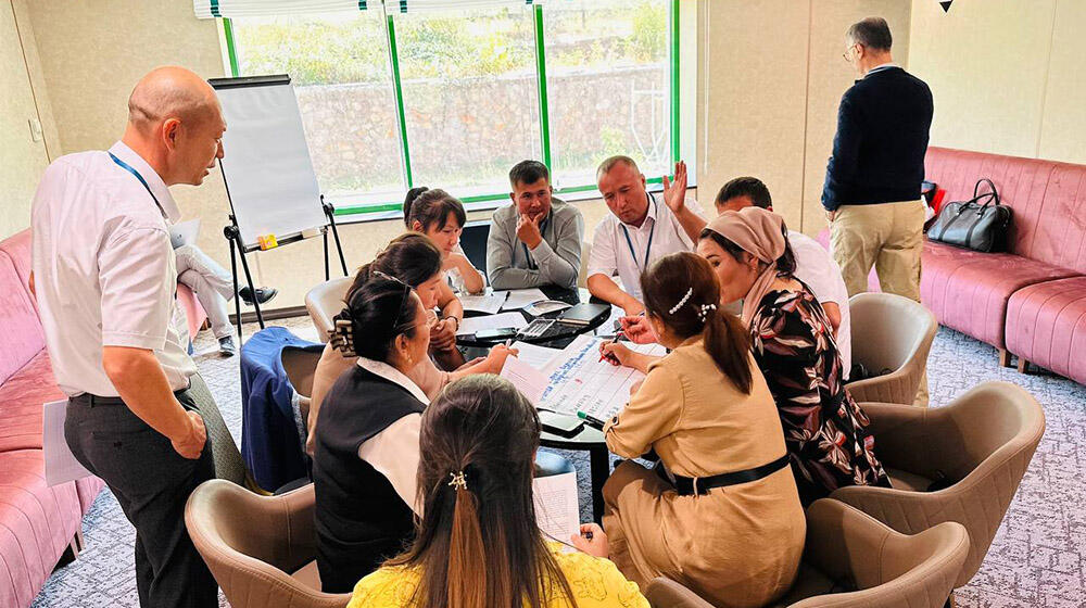 group of people -participants of the meeting sit at the table