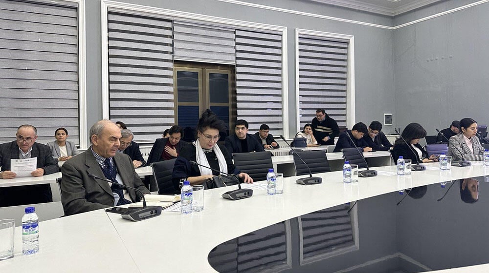 group of people -participants of the meeting sit at the table